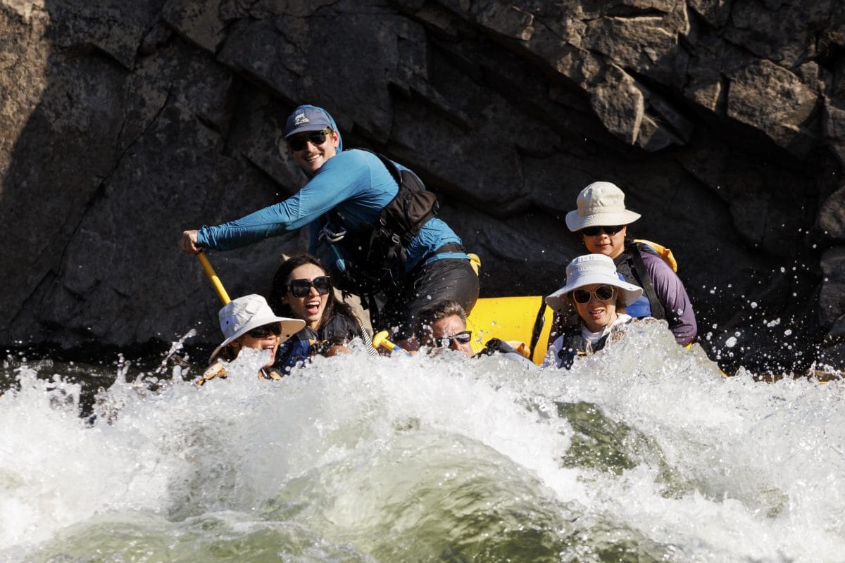 Professional Guide drops raft into big wave.