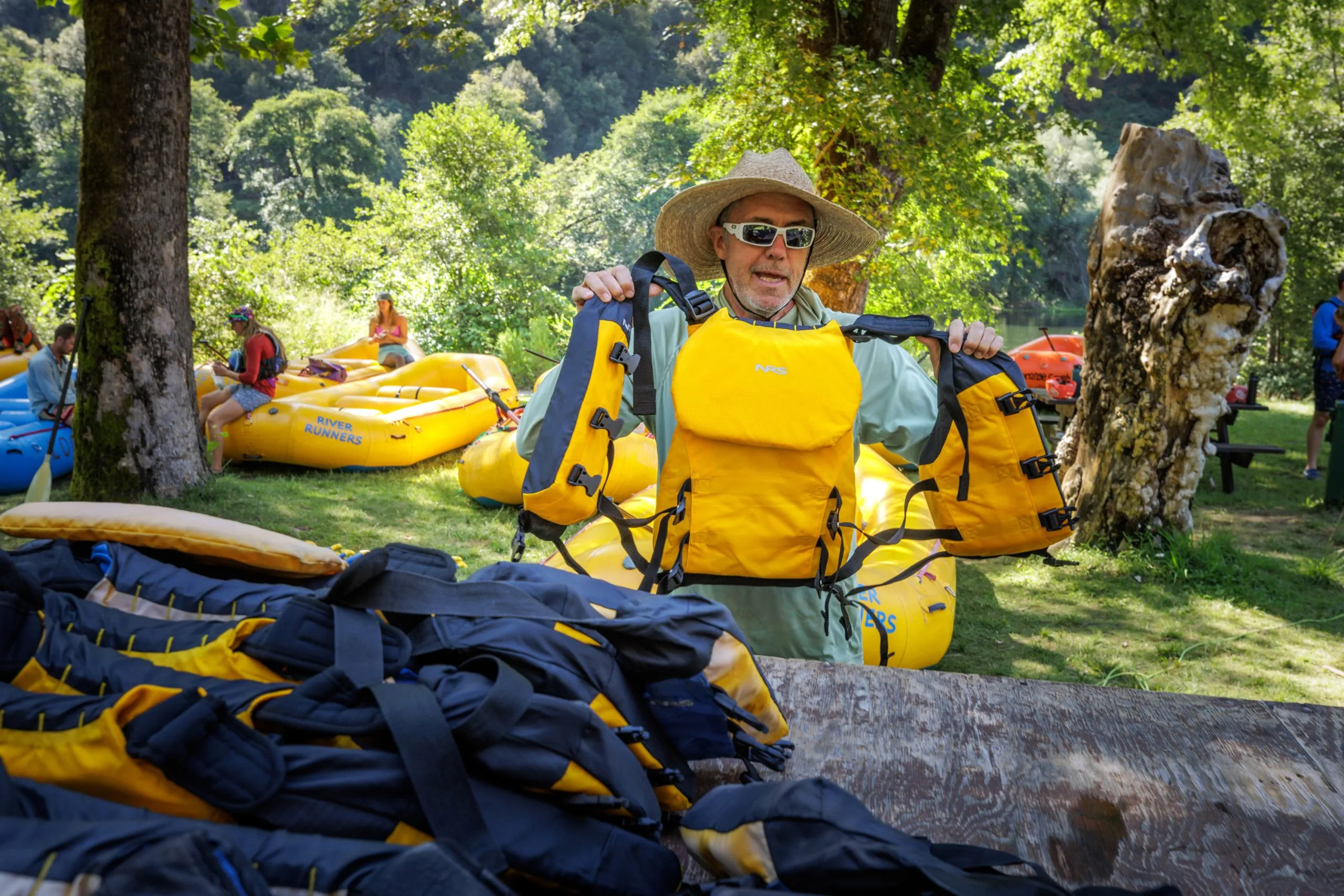 Guide prepares PFDs (Life Jackets) for their American River rafting trip