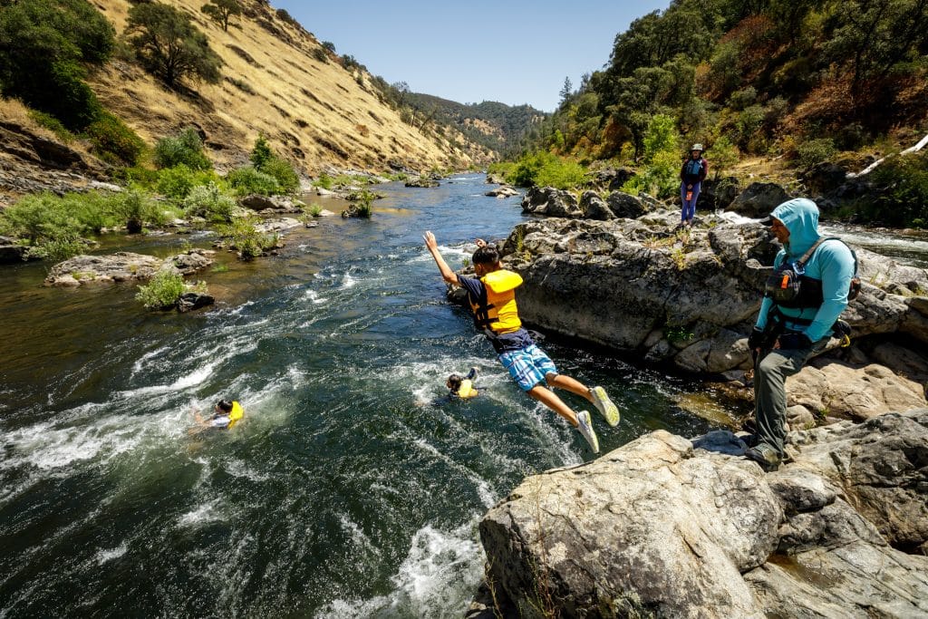 Jumping into the South Fork American River under supervision of guides